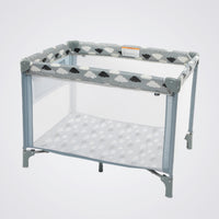 Baby playpen with cloud pattern on a light grey background