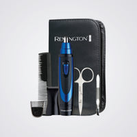 Remington grooming kit with blue and black electric trimmer, comb, and scissors on a Light background