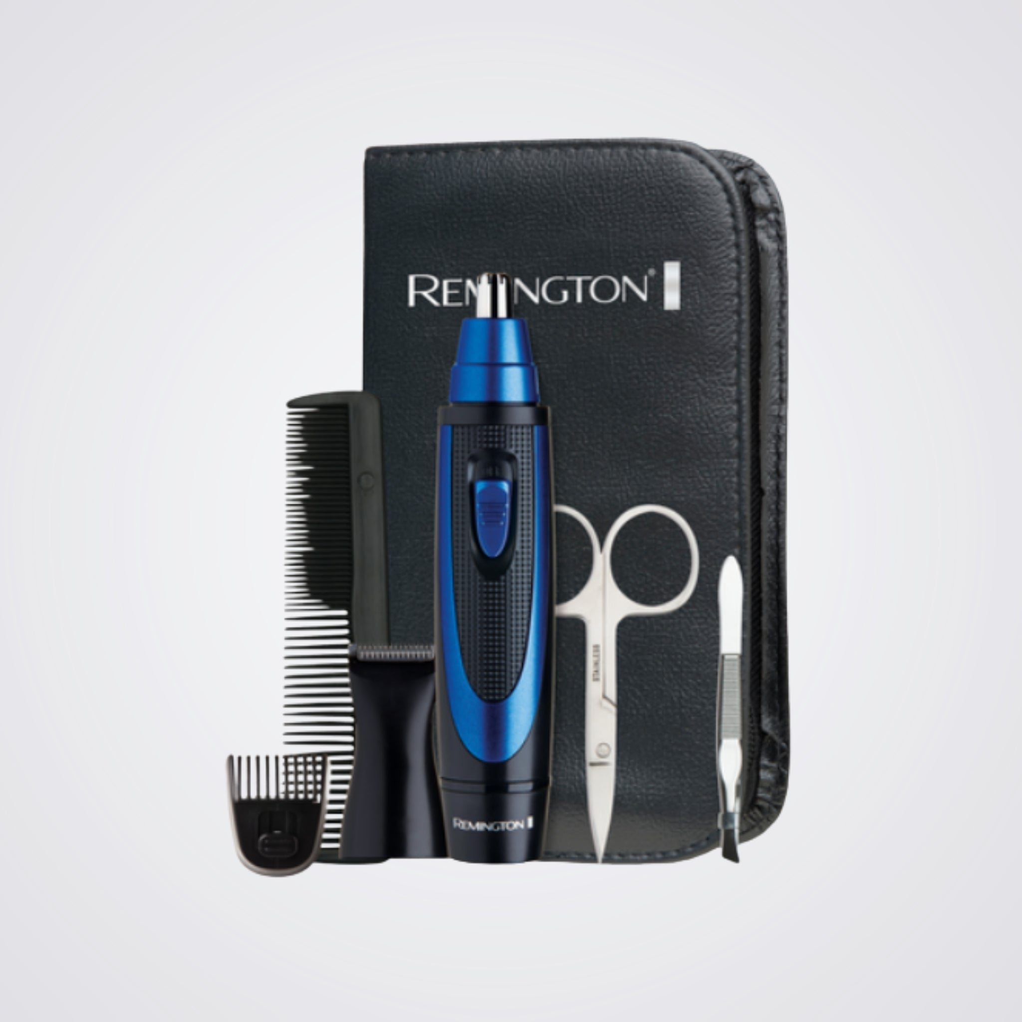 Remington grooming kit with blue and black electric trimmer, comb, and scissors on a Light background