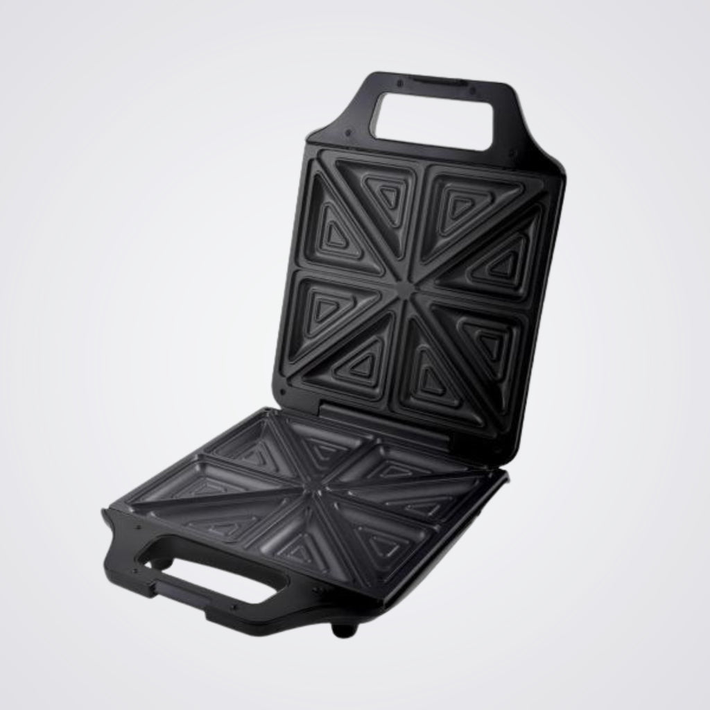 Black Westinghouse sandwich toaster open with geometric patterns on a Light background