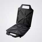 Black Westinghouse sandwich toaster open with geometric patterns on a Light background