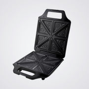 Black Westinghouse sandwich toaster open with geometric patterns on a Light background