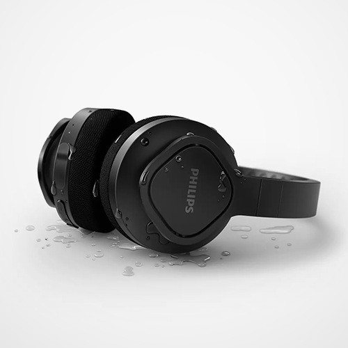 Black Philips headphones on a Light background with water droplets.