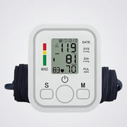 Digital blood pressure monitor on a light background