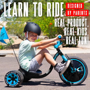 Child riding the blue and black Madd Gear Drift Trike