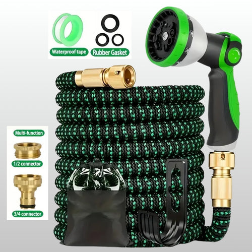 Green expandable garden hose with spray nozzle and connectors on a white background