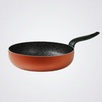 Frying pan with a speckled non-stick coating on a light grey background