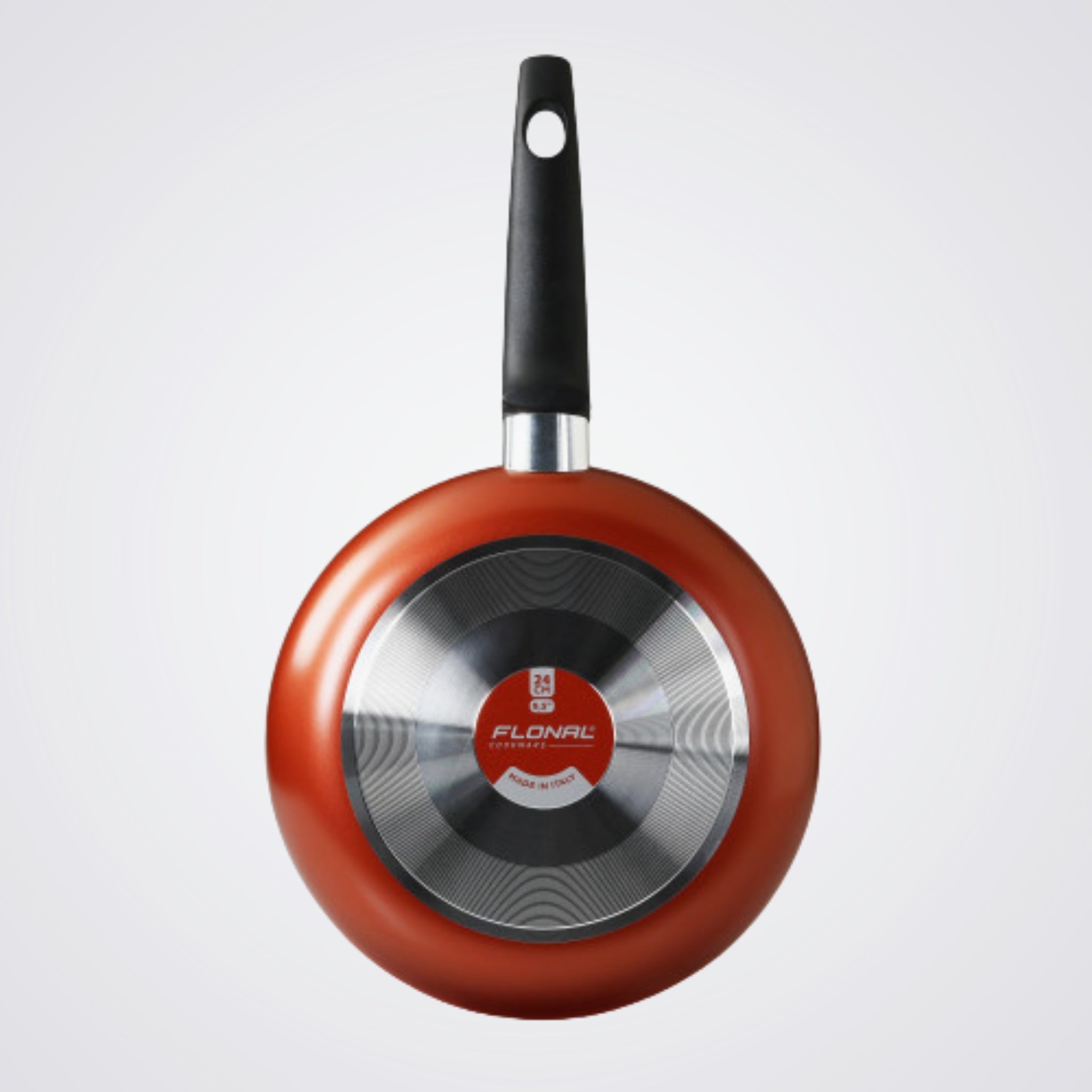 Red frying pan with black handle on a Light background