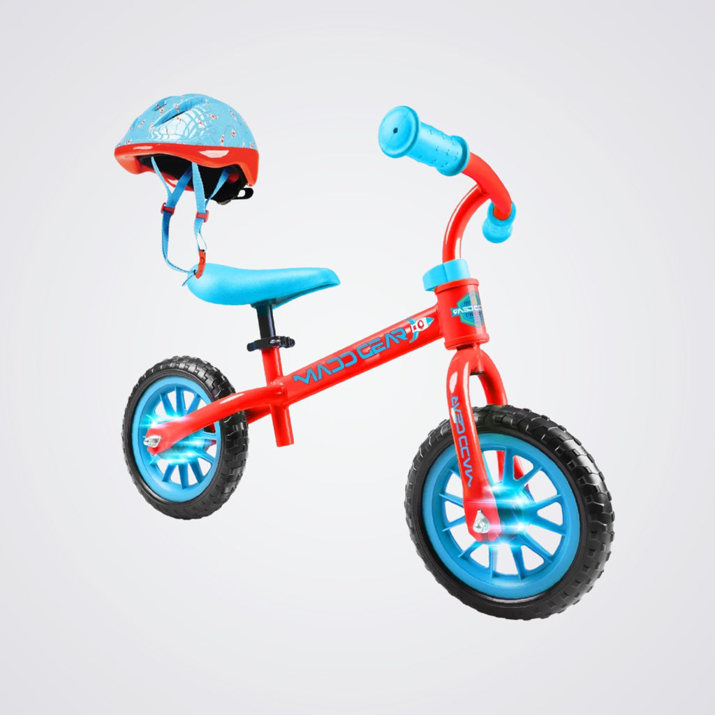 Red and blue balance bike with a helmet on a light grey background