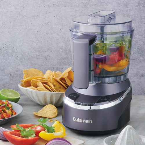Cuisinart food processor with ingredients on a gray surface