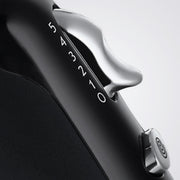 Close-up of a black and silver device with '54321' branding on a light gray background
