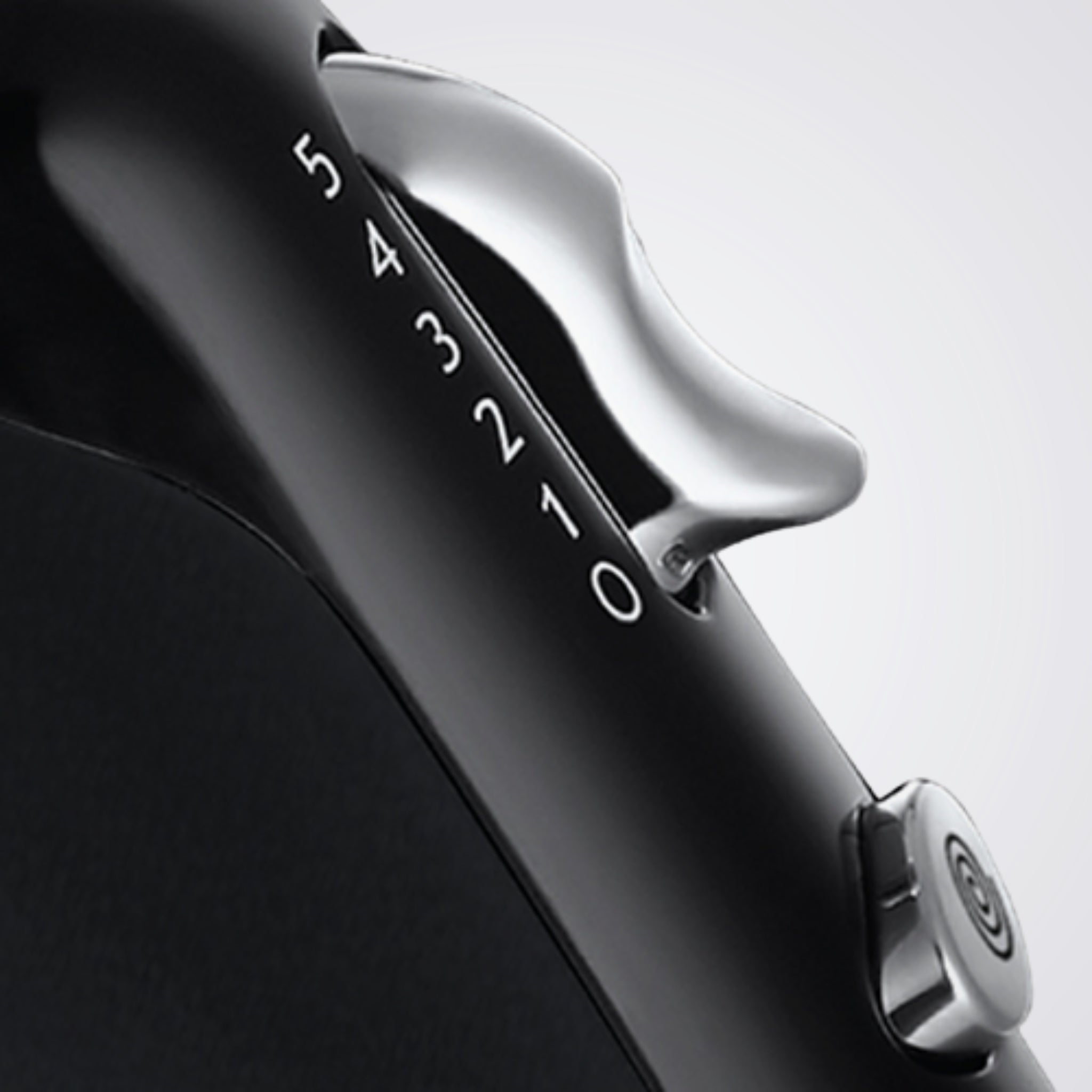 Close-up of a black and silver device with '54321' branding on a light gray background