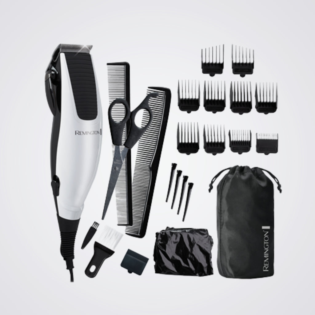 Remington grooming kit with hair trimmer, scissors, combs, and attachments on a light grey background