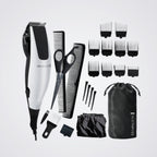 Remington grooming kit with hair trimmer, scissors, combs, and attachments on a light grey background