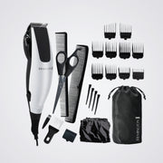 Remington grooming kit with hair trimmer, scissors, combs, and attachments on a light grey background