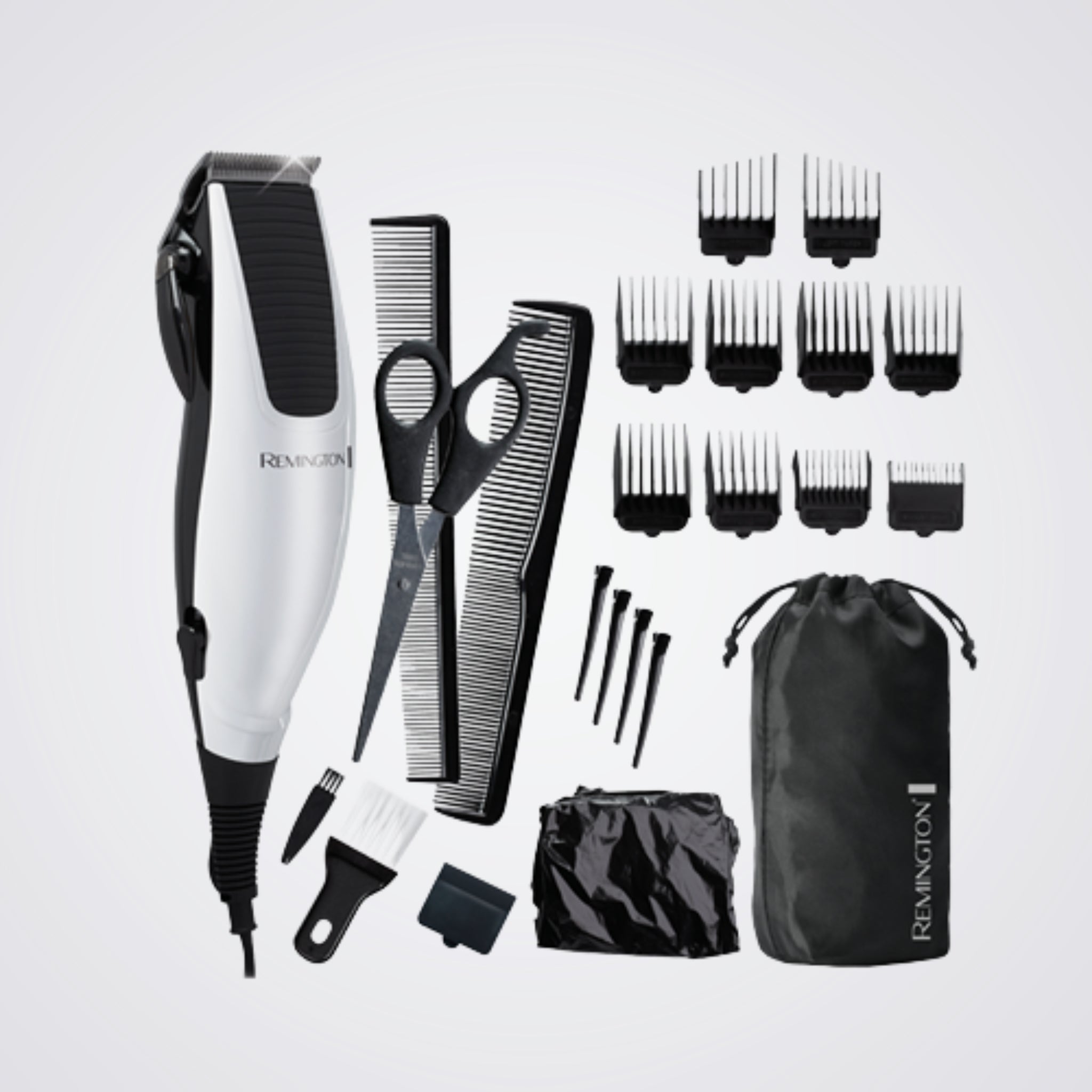 Remington grooming kit with hair trimmer, scissors, combs, and attachments on a light grey background