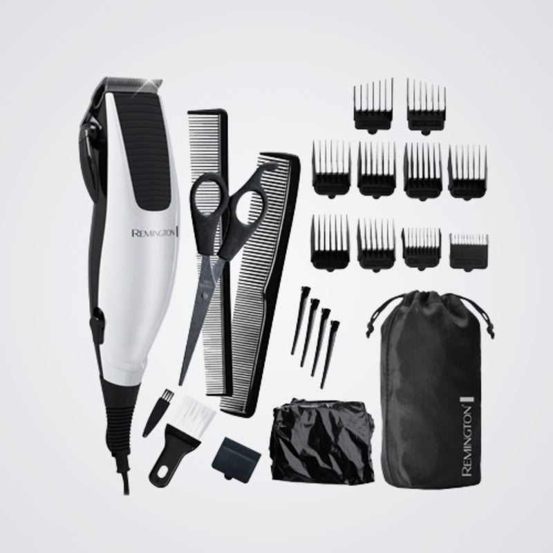 Remington grooming kit with hair trimmer, scissors, combs, and attachments on a light grey background