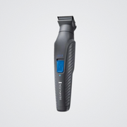 Gray Remington grooming tool on a light gray background